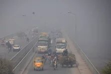 Street photo of people commuting amid smoggy conditions in Lahore, Pakistan on December 2, 2021