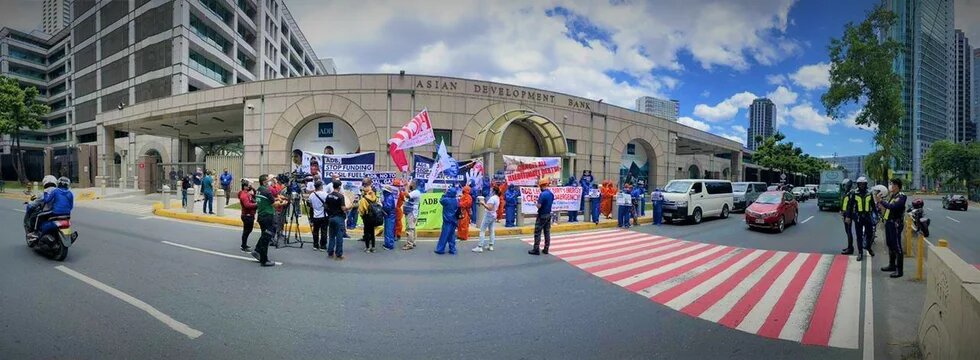 ADB Headquarters' facade with protesters 